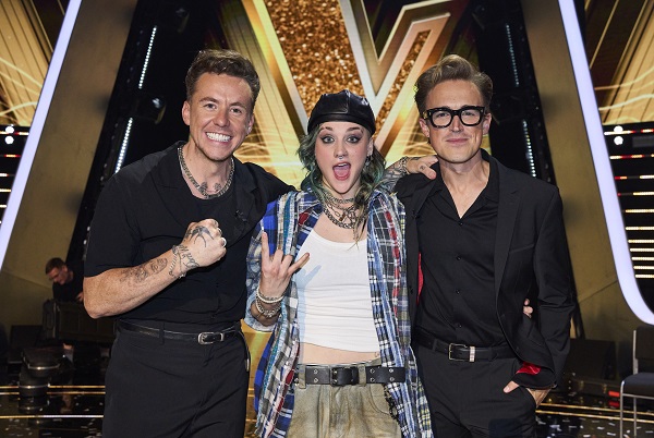 Ava (centre) celebrates with coaches Danny and Tom. Picture: ITV Plc