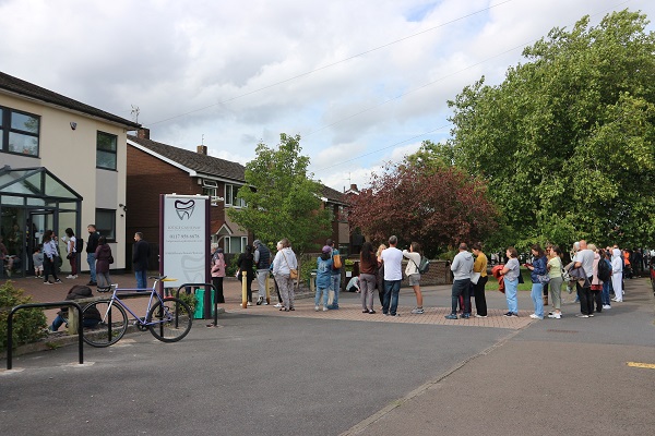 Patients queue outside Lodge Causeway Dental Practice